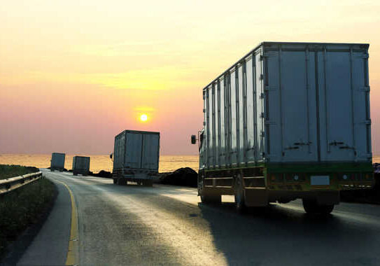 Truck on highway road with container, transportation concept.,import,export logistic industrial Transporting Land transport on asphalt expressway with sunrise sky